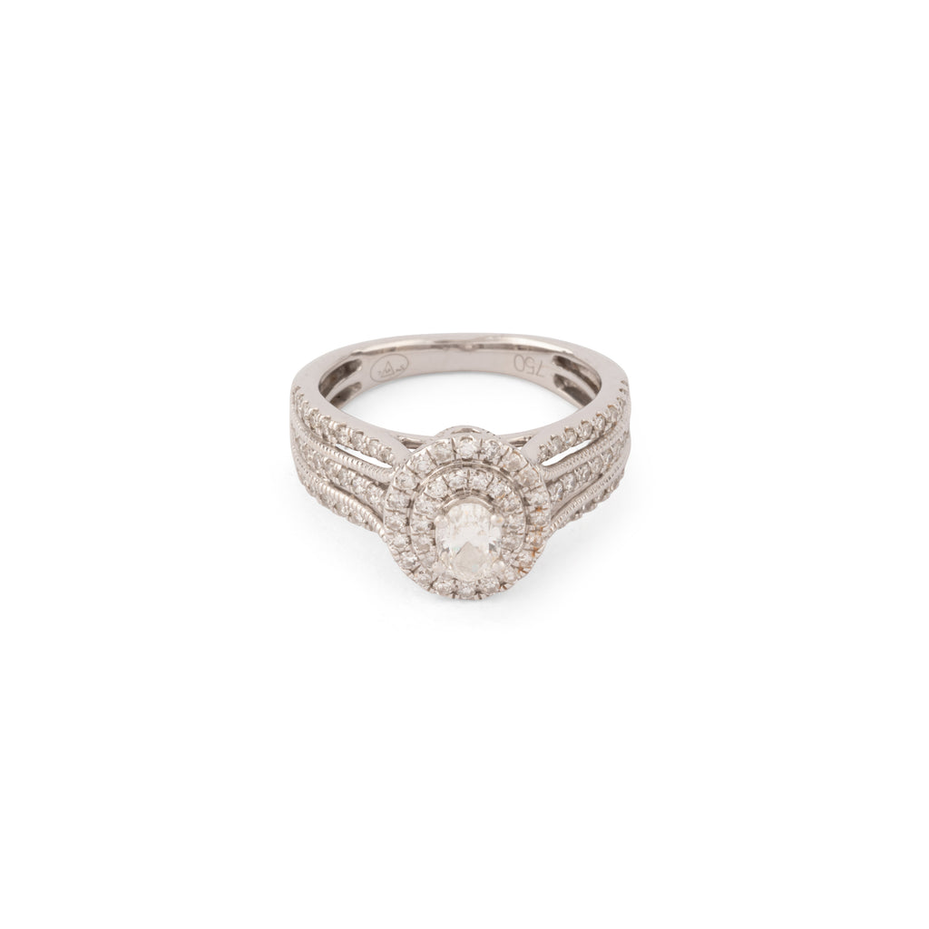 Bague en or gris ornée d'un diamant ovale et pavée de diamants