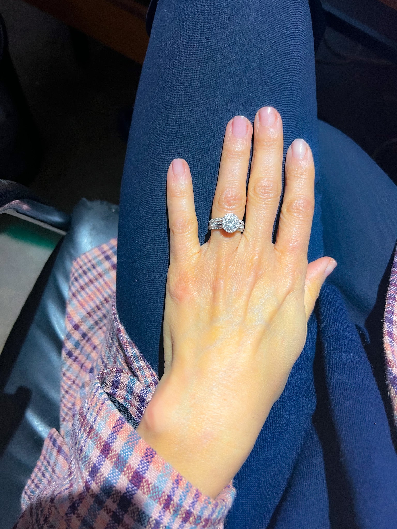 Bague en or gris ornée d'un diamant ovale et pavée de diamants