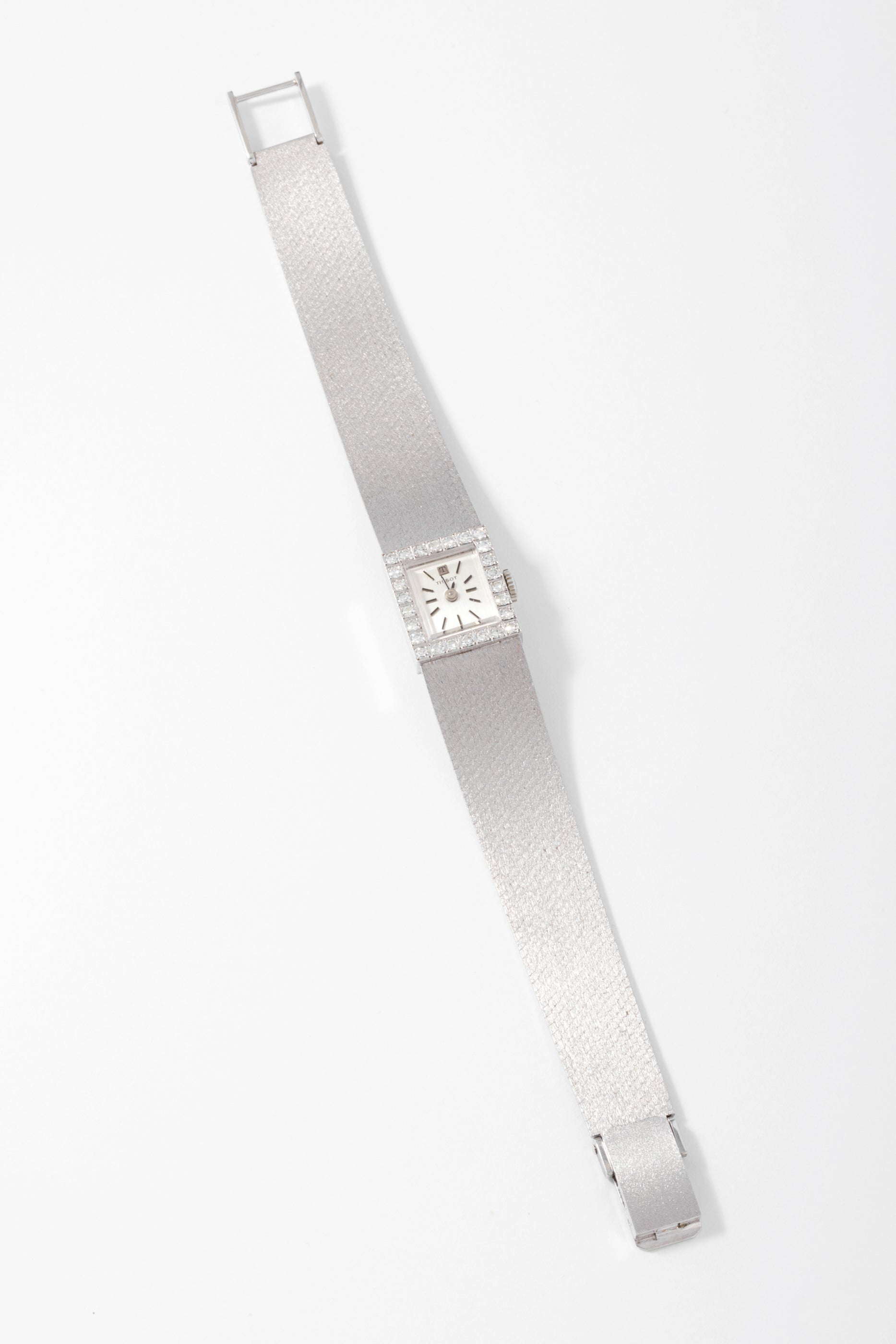 Montre Tissot or gris et diamant datant des années 1960